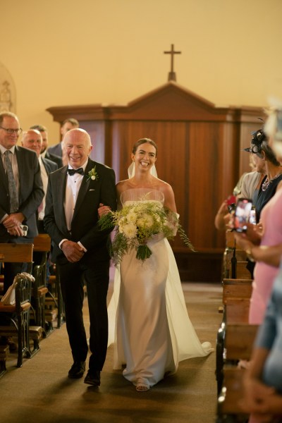 Father of the bride walks down the aisle to groom