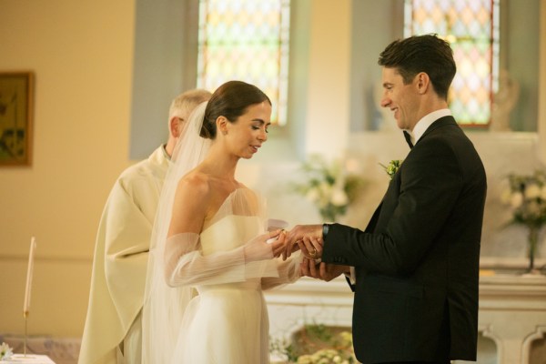 Bride and groom exchange wedding bands rings at the alter