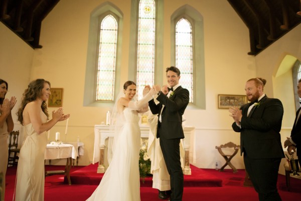 Bride and groom smile at the alter