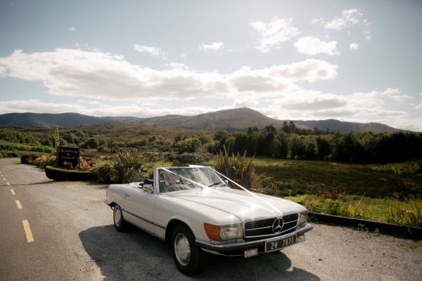 White wedding car against landscape backdrop