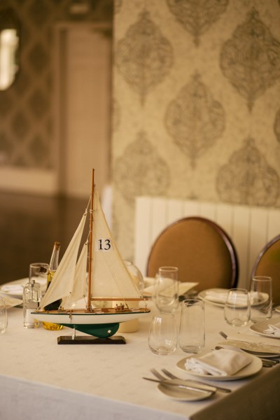 Toy boat on table with cutlery detail