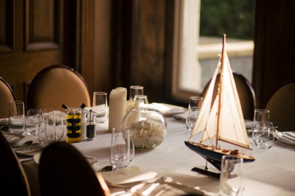 Toy boat on table with cutlery detail