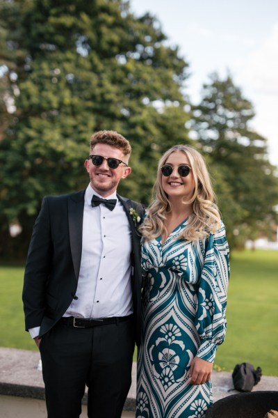 Friends wearing sunglasses pose for a photo