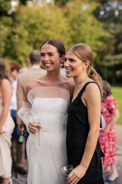 Bride and friend pose for a photo