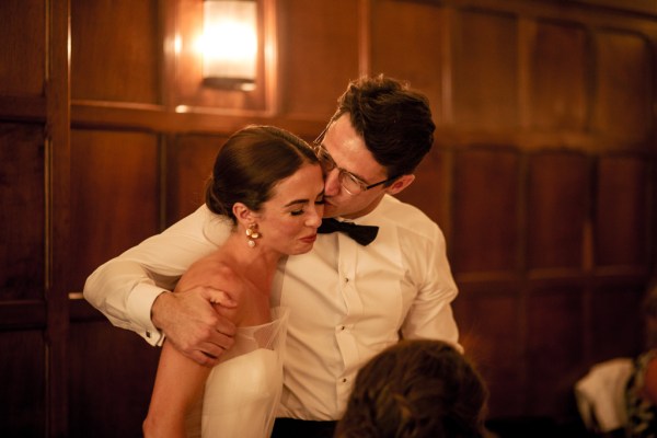 Groom kisses bride on the cheek