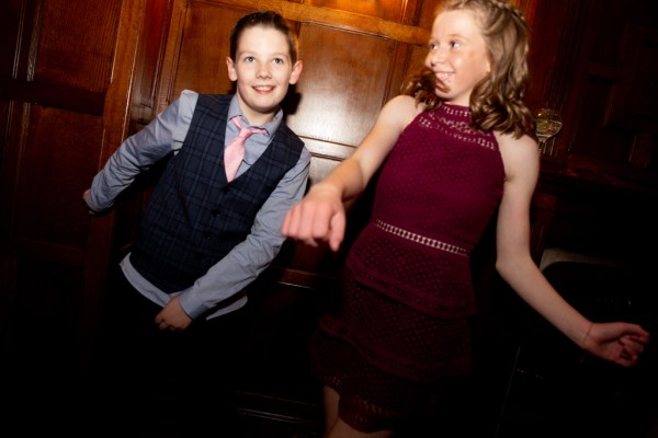 Little boy and girl playing and dancing on dancefloor