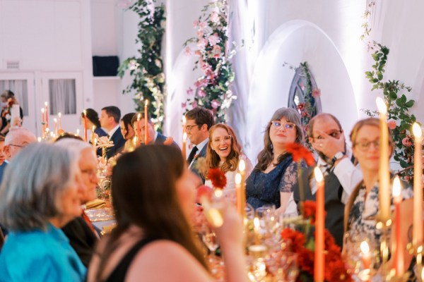 Guests during speeches dining room table bride laughing