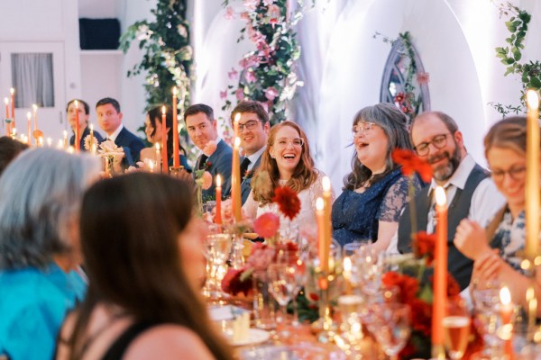 Guests during speeches dining room table bride laughing