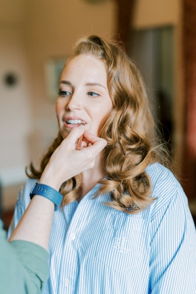 Bride getting her makeup done curly wavy hair