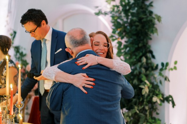 Bride hugs father happy smiles emotional