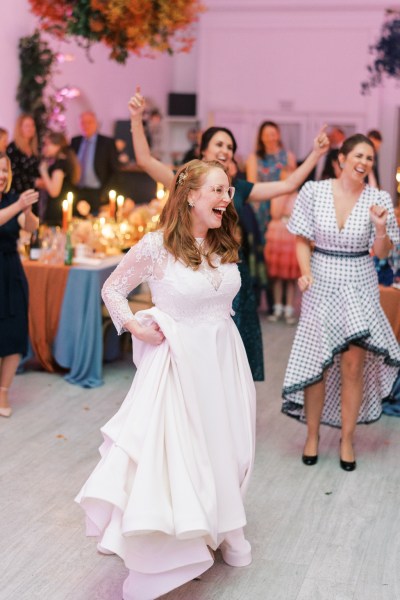 Bride dancing on the dancefloor with guests