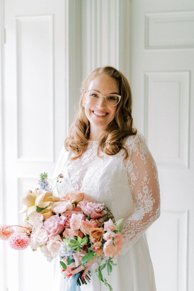 Bride ready for getting holding roses flowers bouquet at window