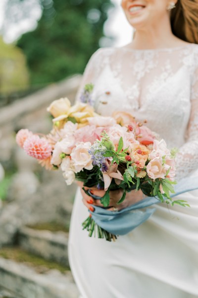 Bride holding bouquet roses flowers