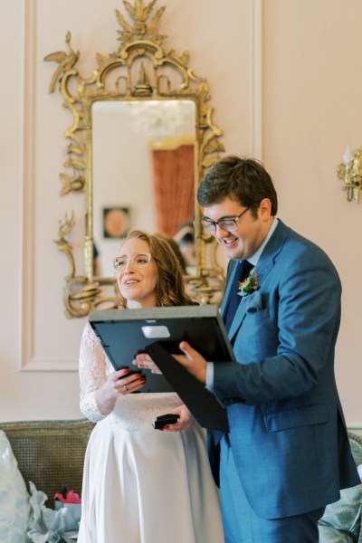 Bride and groom hold photo frame