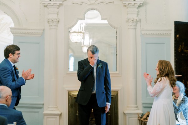 Man father with bride and groom emotional