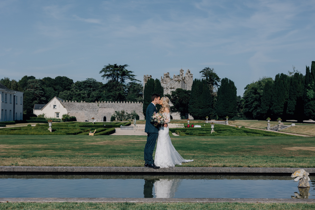 Lake detail couple standing bride and groom kissing on grass