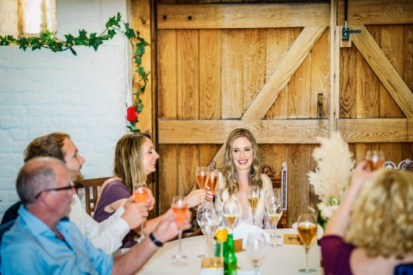 Bride in audience of speeches with family and guests