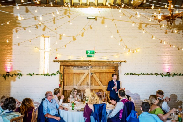 Interior dining room setting with guests during speech