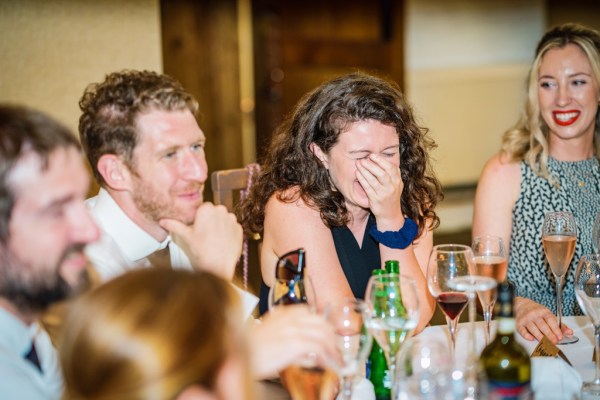 Woman with curly hair laughs during the speeches