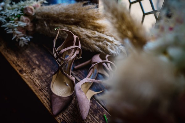 Pink bridal heels/shoes and flowers on windowsill