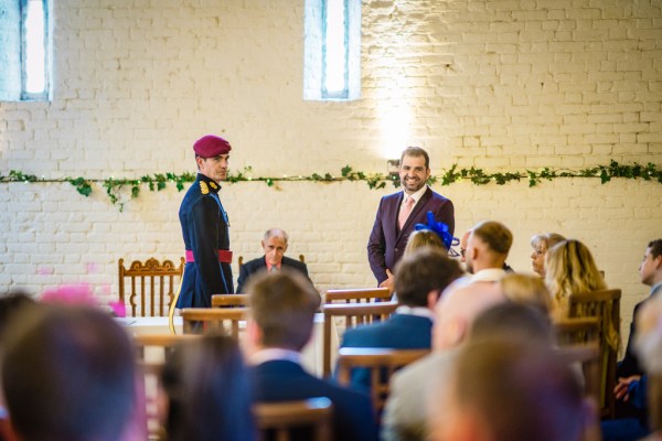 Groom and officiant waiting at the alter