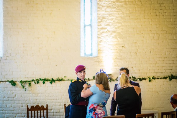 Groom and officiant waiting at the alter woman in blue