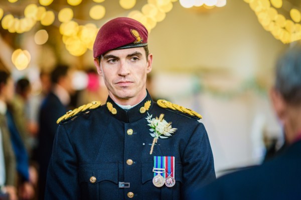 Groom waiting for bride lights in background