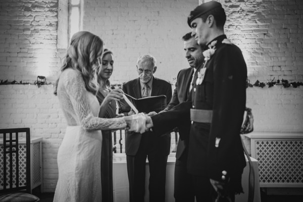 Black and white Bride groom and officiant at alter