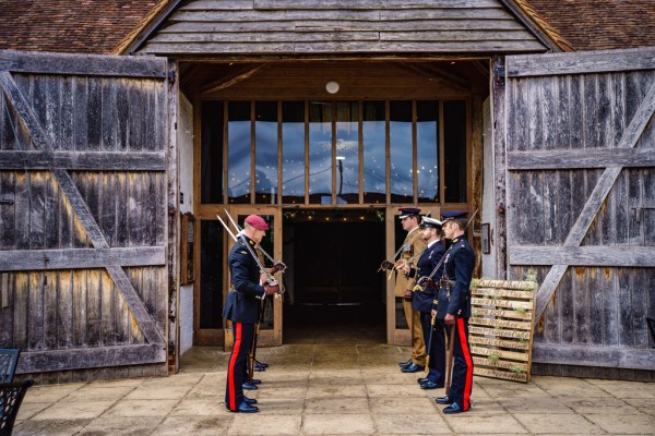 Soldiers waiting outside swords in hand waiting for couple