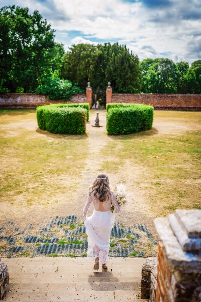 Bride in garden walking down the steps