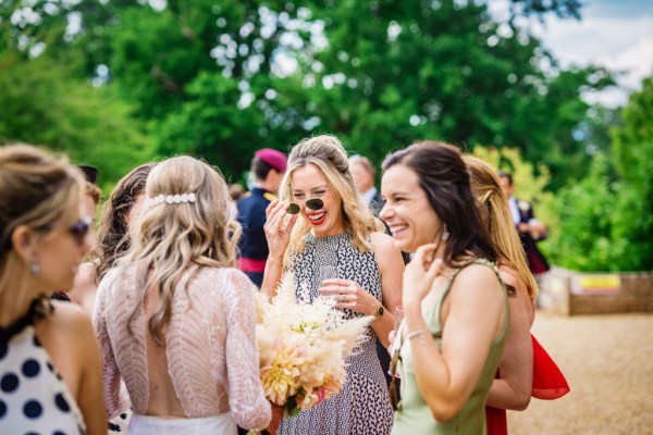 Atmosphere shot of guests and women chatting laughing