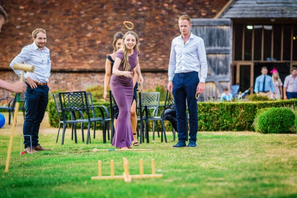 Man and woman playing Polo in garden on grass