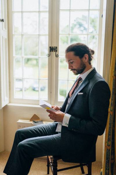 Groom reading my last day fiance letter from bride