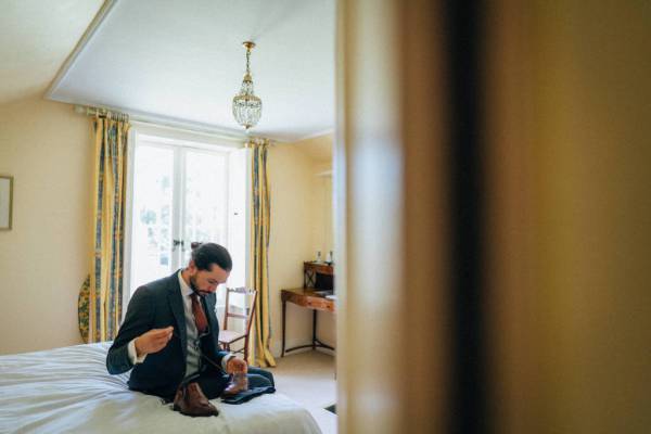 Groom on bed getting ready