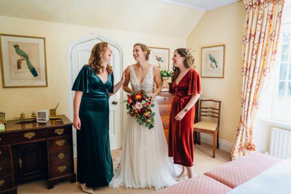 Bride and bridesmaids green red satin dresses pink red roses flowers