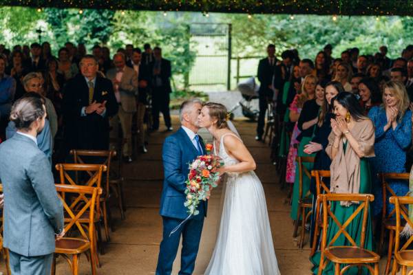 Father of the bride kisses kiss on the cheek wedding ceremony guesys