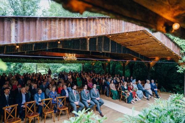 Audience guest members groomsmen and bridesmaids sit at front