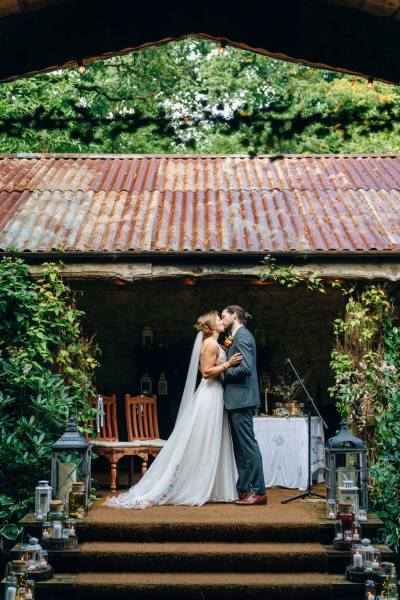 Bride and groom kiss kissing during ceremony