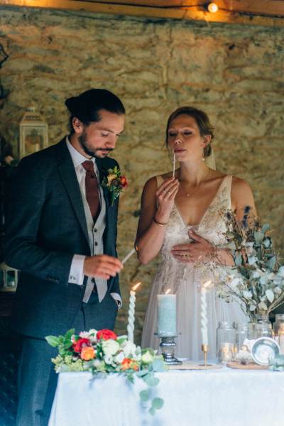 Bride and groom light ceremonial candles