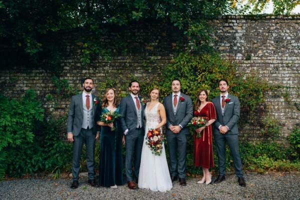 Group shot bride groom bridesmaids and groomsmen garden