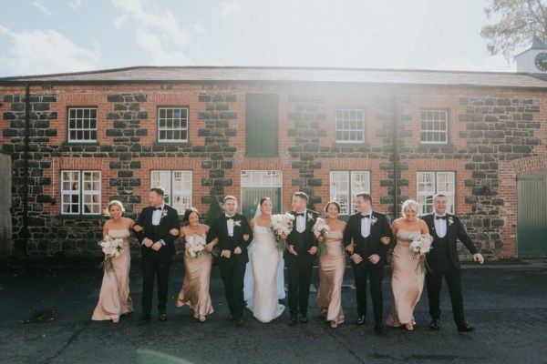 Bridesmaids bride groom and groomsmen outside wedding venue