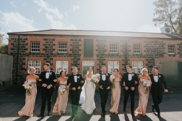 Bridesmaids bride groom and groomsmen outside wedding venue