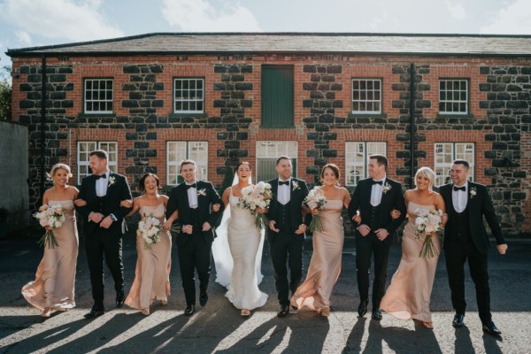 Bridesmaids bride groom and groomsmen outside wedding venue