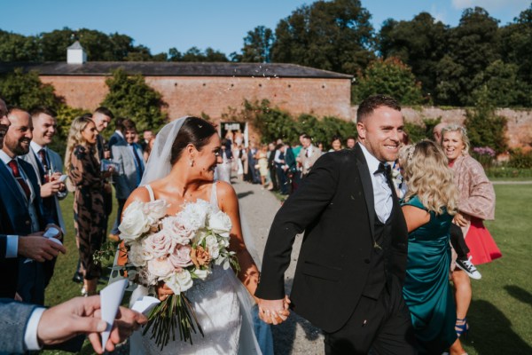 Atmosphere shot just wed couple bride and groom confetti guests