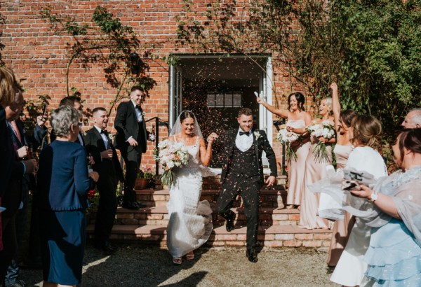 Atmosphere shot just wed couple bride and groom confetti guests