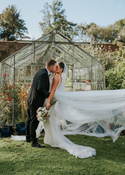 Bride and groom veil blowing in the wind couple kiss kissing