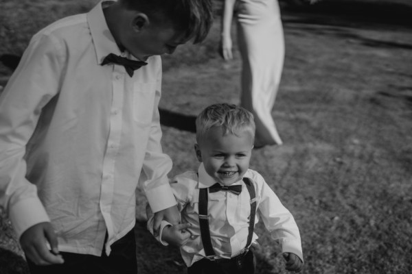 Black and white children and baby in suits