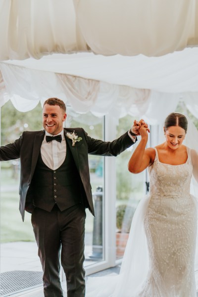 bride and groom enter the ballroom