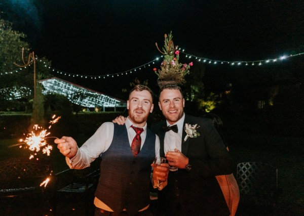 Groom and best man nighttime shot outside