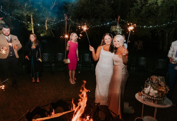 Bride dancing with bridesmaids sparklers